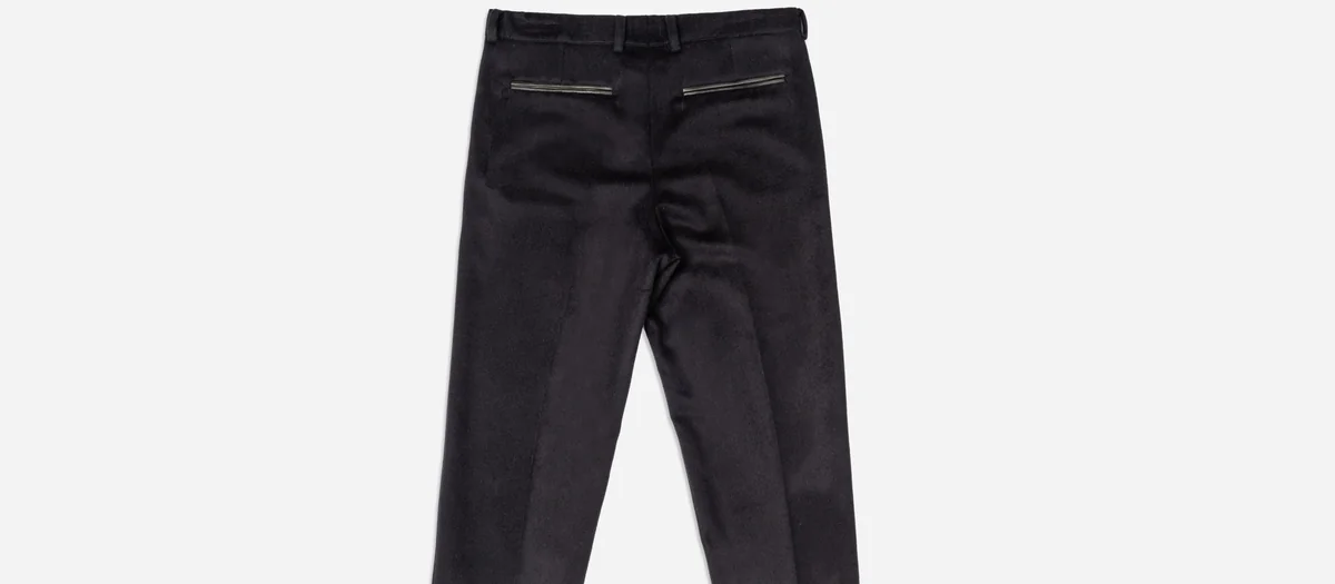 Black trousers photographed as a clean product flat on a light background