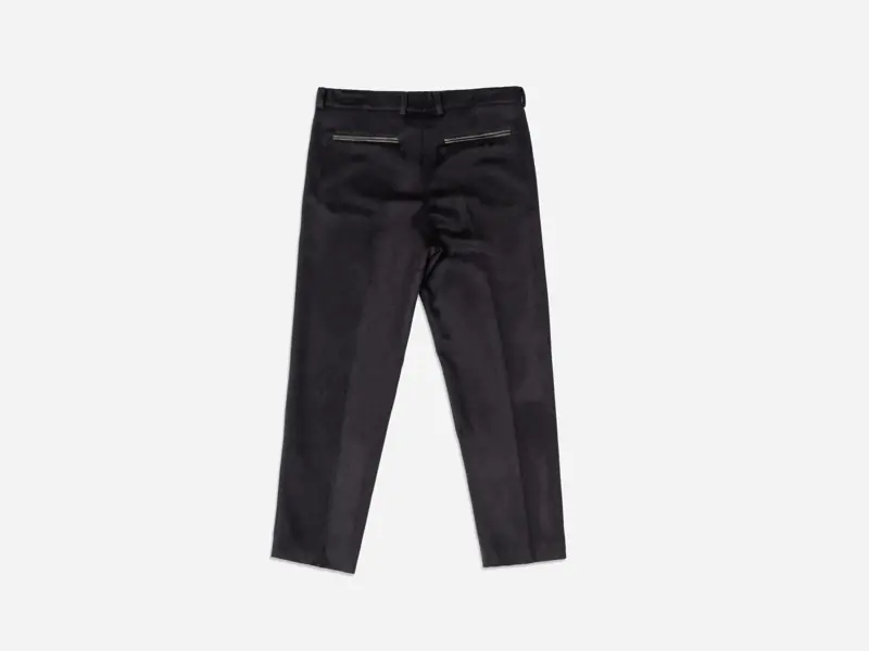 Black trousers photographed as a clean product flat on a light background